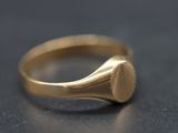 a close up of a gold ring on a black surface