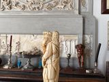 a statue of a woman on a mantle in a room