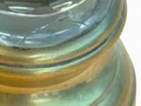 a close up of a glass vase with a bird on it