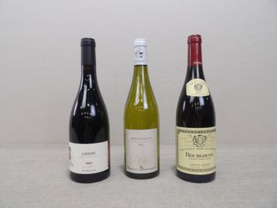 three bottles of wine sitting on a table next to each other