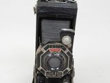 an old camera that is sitting on a white surface