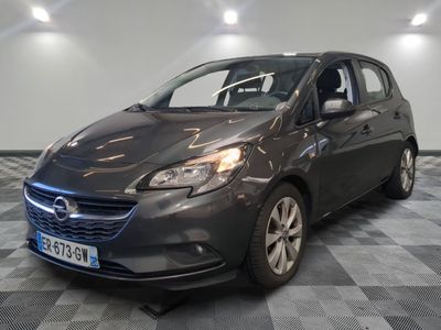 the grey opel is parked in a room with a checkered floor