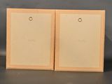 pair of wooden picture frames on a table with a gray background
