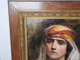 painting of a woman with a head scarf in a wooden frame