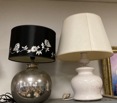two lamps that are on a shelf next to a picture