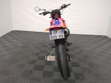 a motorcycle that is parked in a room with a checkered floor