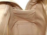 beige leather purse with zippers and a zippered pocket