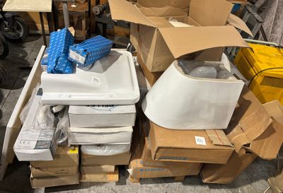 a pile of boxes and a sink in the middle of a room