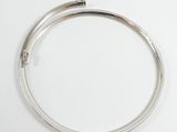 an image of a close up of a silver bracelet on a white surface