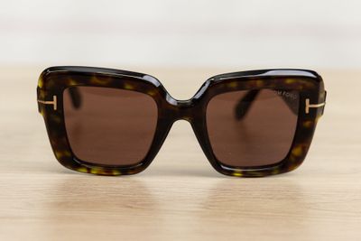 a pair of sunglasses sitting on top of a wooden table