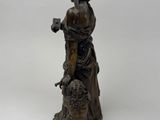 bronze statue of a woman with a dog on a white background