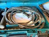 a blue tool box filled with tools on a wooden floor