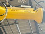 a yellow robot hanging from the ceiling of a building