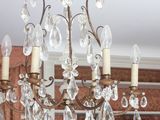 a chandelier hanging from the ceiling in a living room