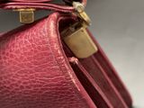 a close up of a red purse with a lock on it
