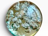 a picture of a glass button with a flower design on it