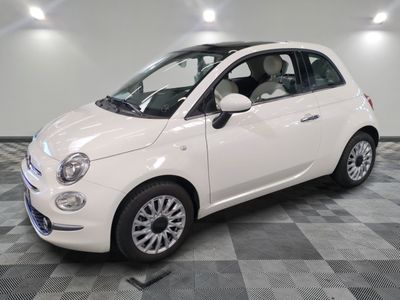 a picture of a small white car parked in a garage