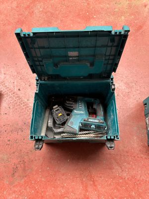 a blue tool box with tools in it on the floor