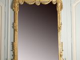 a mirror that is on a mantle in a room