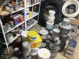 many cans of paint and cans of paint on the floor