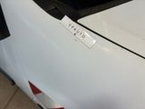 a sticker on the hood of a white car