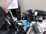 many different types of cameras and accessories on the table