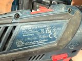 a person holding a cordless drill in their hand