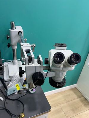 two microscopes sitting on a table in a room