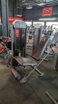 a gym with a lot of machines in the room
