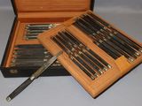 a wooden box with a set of knives in it