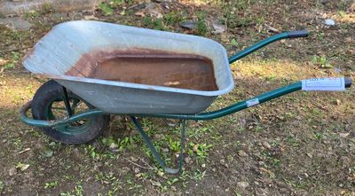 a wheelbarrow that is sitting in the grass