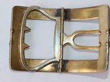 a gold belt buckle with a metal buckle on it