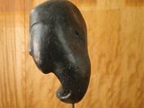 a statue of an elephant head on a wooden stand