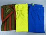 three pairs of men ' s pants, one blue, one yellow and one red
