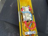 a close up of a yellow box with wires attached to it