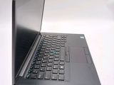 a laptop computer sitting on a table with a keyboard