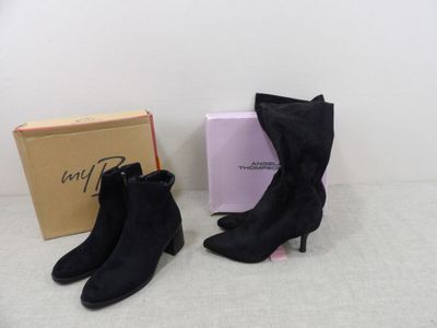 a pair of black sued ankle boots next to a box