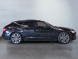 a black car parked in a garage with a white wall