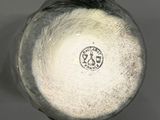 a close up view of a white vase with a black base