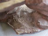 a close up of a cake with chocolate frosting on it
