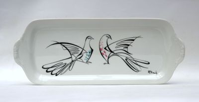 a white tray with two birds painted on it