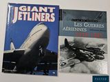two books of giant jetliners on a white surface