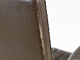 brown leather reclining chair with arm rests on a white surface