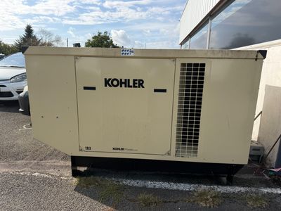 a small generator that is sitting in the parking lot