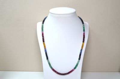 multicolored beaded necklace on a mannequin with a white mannequin