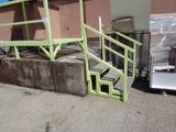 a green ramp next to a building with a microwave on it