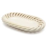 the white plate is shaped like a basket with a rope around it