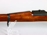 an old rifle with a wooden barrel on a white background