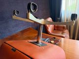 an orange suitcase sitting on a wooden table in front of a window