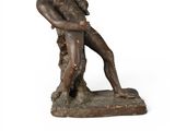 bronze statue of a man holding a bird on a white background